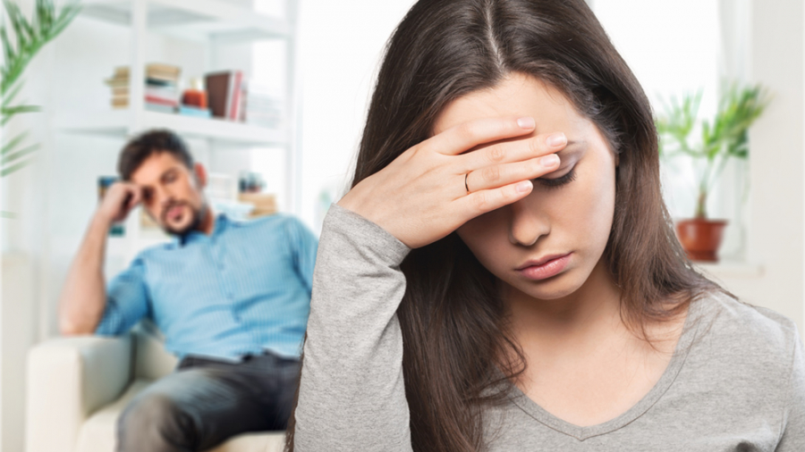 Sad young couple sitting on sofa