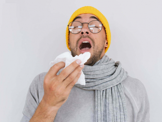 portrait-sick-handsome-man-wearing-grey-sweater-yellow-hat-spectacles-blowing-nose-sneeze-into-tissue-male-have-flu-virus-allergy-respiratory-healthy-medicine-people-concept